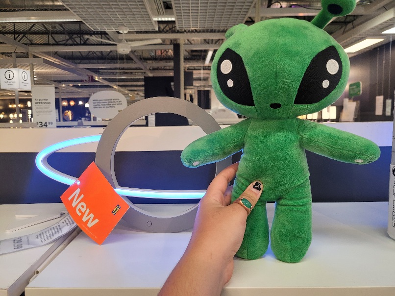 me holding the plush next to a planet light