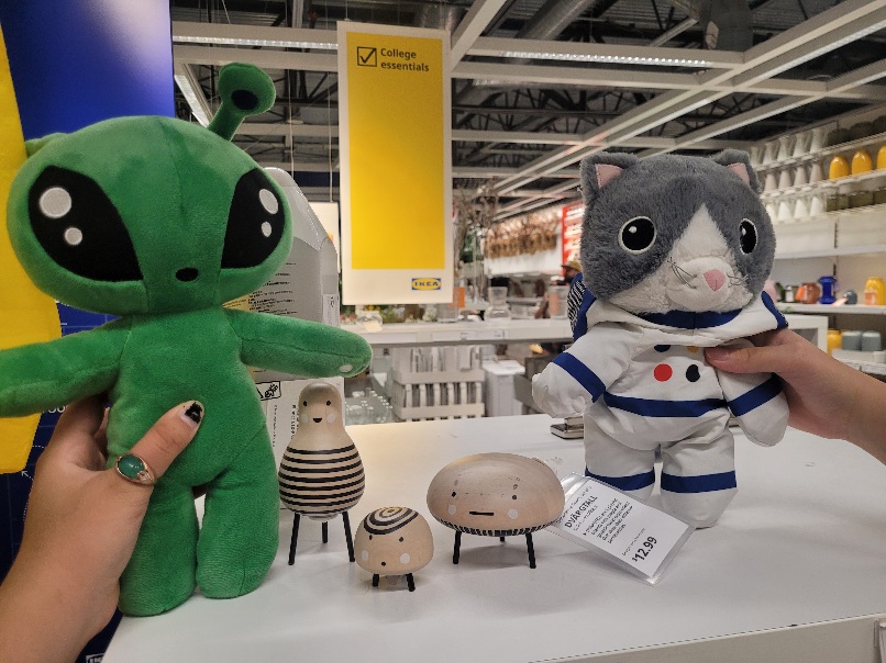 both plushies being held next to some strange ikea goobers